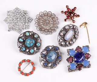 A silver gilt star shaped bar brooch set red stones, a silver filigree brooch, a diamonte brooch, a gilt stick pin in the form of a Kiwi  and 5 polished hardstone brooches