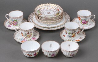 A 18 piece Dresden tea service with floral decoration comprising large plate, medium plate, side plate (chip to rim), 4 large saucers (2 f and r),  4 small saucers (2 cracked), 4 tall cups (1 cracked), 3 squat cups (2 cracked), bases marked Dresden 