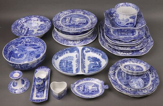 A collection of 26 items of Copeland Spode Italian pattern blue and white tableware comprising 2 graduated meat plates, pair of meat plates, twin handled bread plate, square bowl, circular comport, oval twin section dish, bowl, 3 segmented plates, jardiniere, cake platter, 2 panelled bowls (1 cracked), bowl (cracked), 2 small oval bowls, leaf shaped dish, rectangular condiment tray, salt pot, mustard, stub shaped candlestick (chip to base), heart shaped box (no lid) and a small saucer, all varying dates 