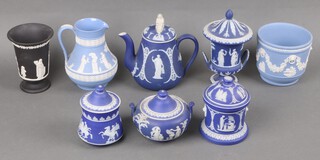 A 19th Century Wedgwood blue Jasper Ware teapot, the finial in the form of a seated lady (crack to base), ditto two handled sugar bowl and cover 9cm base impressed V, Wedgwood jar and cover with associated lid, chassepot 11cm, jug base impressed 30 14cm, a black Jasper Ware trumpet shaped vase impressed 74 19cm, a 19th Century Wedgwood blue and white twin handled urn and cover (lid stuck) and a circular jar and cover (lid f) 