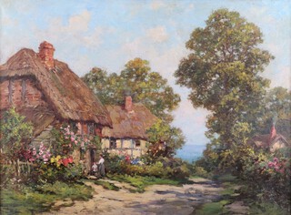 Tom Mostyn (1864-1930), Figures before a Thatched Cottage, oil on canvas, signed, 50cm x 67cm, within a swept gilt composition frame.