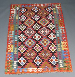 A black, red and orange ground Maimana Kilim rug with overall geometric design 193cm x 128cm 