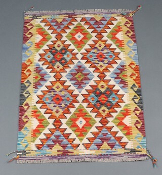 A white, green and orange ground Chobi Kilim rug with all over diamond design 120cm x 79cm 