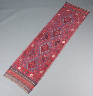 A red and blue ground Meshwani runner with 4 diamonds to the centre 235cm x 64cm 