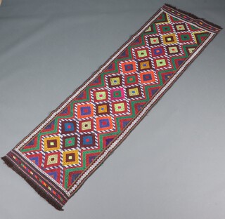 A green, orange, blue and white ground Suzni runner with numerous diamonds to the centre 245cm x 68cm 