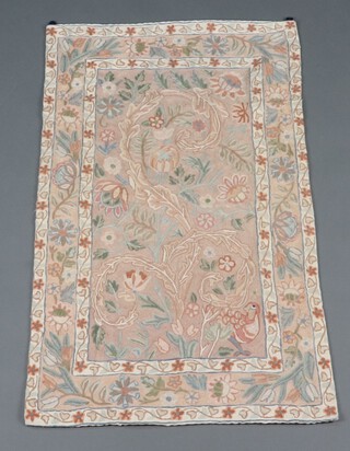 A Kashmiri style stitched panel decorated bird amidst flowers 111cm x 69cm 