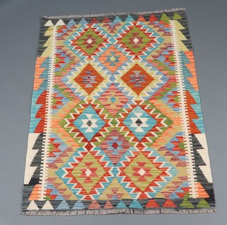 A black, green and white ground Chobi Kilim rug with diamond decoration 144cm x 102cm 