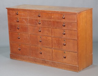 A Victorian rectangular oak chest of 5 short drawers flanked by 5 long drawers with turned handles, raised on a platform base 94cm h x148cm w x 49cm d  