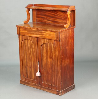A Regency mahogany chiffonier, the raised back fitted a shelf, fitted a drawer above cupboard enclosed by a pair of arched panelled doors, raised on a platform base 119cm h x 78cm w x 37cm d 