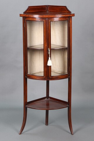 An Edwardian inlaid mahogany corner display cabinet with raised back, fitted shelves enclosed by glazed panelled doors above undertier, raised on outswept supports 129cm h x 54cm w x 38cm d 