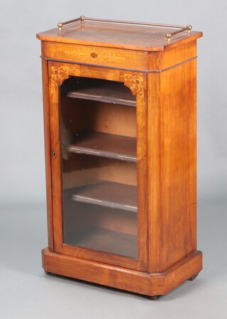 A Victorian inlaid walnut music cabinet with tubular gilt metal three-quarter gallery, fitted shelves enclosed by a glazed panelled door, raised on a platform base 97cm h x 55cm w x 33cm d 