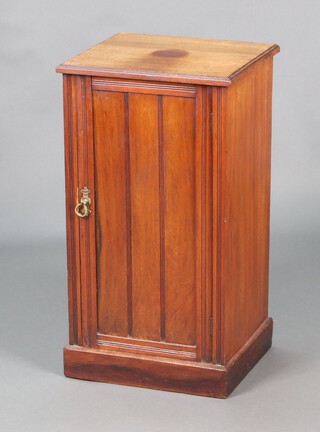 An Edwardian walnut pot cupboard with shelved interior enclosed by a panelled door, raised on a platform base 69cm h x 38cm w x 34cm d 