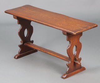 A 1930's rectangular oak refectory style bench/table, raised on pierced standard end supports with H framed stretcher 47cm h x 91cm w x 31cm d 