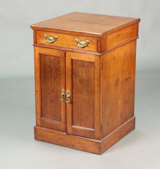 An Edwardian walnut cabinet, the upper section fitted a drawer, the base fitted a shelf and later filing drawer enclosed by a pair of panelled doors, raised on a platform base 81cm h x 53m w x 55cm d 