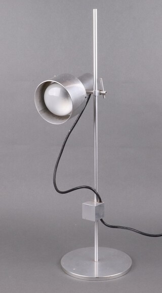 A mid-Century brushed chrome adjustable table lamp on a circular base 61cm h 