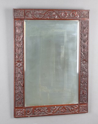 A Victorian rectangular bevelled plate wall mirror in a carved oak frame 75cm x 54cm 