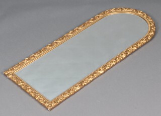A 1950's arched bevelled plate mirror contained in a gilt painted plaster frame 113cm x 46cm 