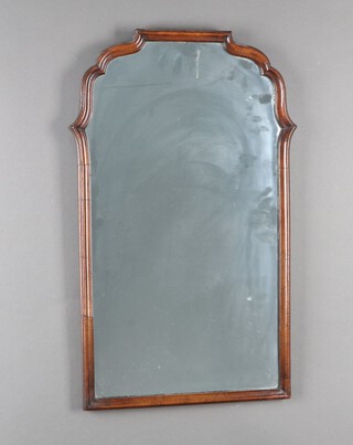 A Queen Anne style shaped plate dressing table mirror contained in a walnut frame 72cm x 44cm 