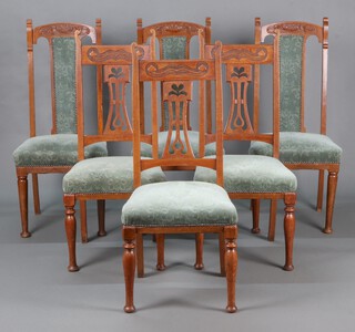 A harlequin set of 6 Art Nouveau Liberty style carved oak high back dining chairs comprising 3 carved oak dining chairs with pierced vase shaped slat backs and over stuffed seats, raised on turned supports 105cm high x 46cm w x 43cm d and 3 similar high back dining chairs with carved cresting rail, upholstered splat backs, raised on turned supports 107cm h x 47cm w x 43cm d 