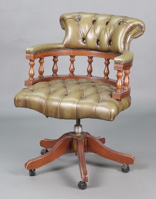 A beech framed Captain's revolving office chair upholstered in green buttoned leather 87cm h x 62cm w x 56cm d 