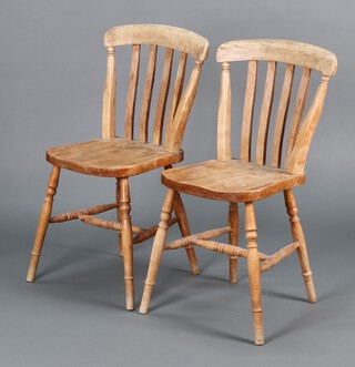 A pair of 19th Century bleached beech stick and rail back Windsor kitchen chairs on turned supports with H framed stretcher 84h x 36w x 38d 