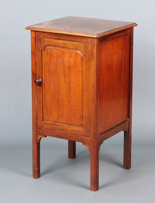 An Edwardian mahogany bedside cabinet enclosed by a panelled door, raised on square tapered supports 71h x 38w x 37d 