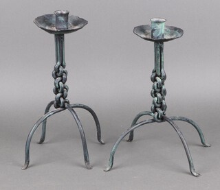 A pair of wrought iron candlesticks with drip trays 30cm