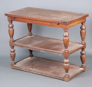 A 1930's rectangular oak 3 tier buffet converting into a draw leaf dining table 73h  (signs of old but treated worm) 