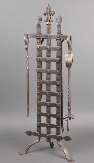 A pierced metal fireside companion stand with poker, tongs and brush (head a/f) and 2 toasting forks