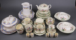 A 1930's fifty one piece Homeleigh floral pattern tea/dinner service comprising 2 shallow lidded tureens and covers (cracked), 6 dinner plates (3 cracked), 6 side plates (2 cracked), 6 tea plates, tea pot, preserve jar and cover (some crazing), cream jug, sugar bowl, 6 egg cups, rectangular sandwich plate (cracked), 6 square sandwich plates (1 cracked), 6 cups, 6 saucers (3 saucers cracked), shallow sauce boat (cracked and chipped) and a teapot stand (cracked) together with a twelve piece Ivory Old Eaton dinner service comprising 3 graduated meat plates (2 cracked), a tureen and cover (cracked), a pottery jug, 3 dinner plates (cracked), 2 twin handled butter plates and 2 circular plates (cracked)