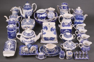 A collection of blue and white china, various manufacturers, to include teapots, milk jugs, condiments, toast rack, cheese dish and cover, bowls etc 