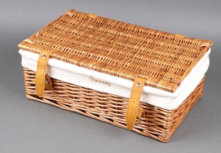 A rectangular wicker work hamper with hinged lid marked Harrods 14h x 43w x 26d 