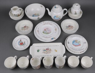 Thirty one pieces of Wedgwood Beatrix Potter Ware decorated Peter Rabbit and other characters, comprising 2 dinner plates, 3 side plates, 3 tea plates, 3 bowls, 2 shallow dishes, rectangular plate, 2 shallow bowls, pedestal bowl, jar and cover, cream jug, teapot, 4 cups (1 cracked), 4 saucers, 3 mugs PLEASE NOTE: THIS LOT NO LONGER CONTAINS THE RUPERT BEAR ITEMS AS ORIGINALLY CATALOGUED.
