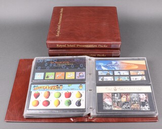 Three ring bound albums of Elizabeth II presentation stamps 