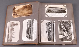 An album of approximately 48 black and white and coloured postcards including locomotives and war ships 