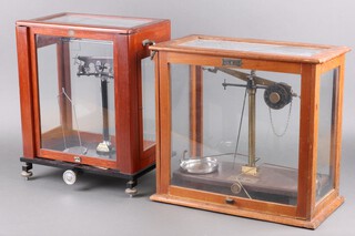 Griffin Tatlock, a pair of laboratory scales in a mahogany case 40h x 45w x 23d and Baird and Tatlock a pair of laboratory scales in a mahogany case 44h x 34w x 22d 