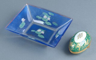 A French green and gilt glazed porcelain trinket box in the form of an egg 3cm together with a Goebel Claude Monte rectangular blue glass dish decorated lilies (chip to rim) 