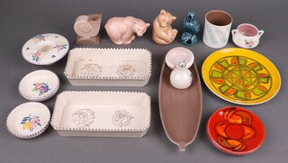 A Poole Pottery figure of a standing bear, two rectangular Poole pottery dishes, two Poole pottery Atomic orange circular dishes and a collection of small items of Poole pottery