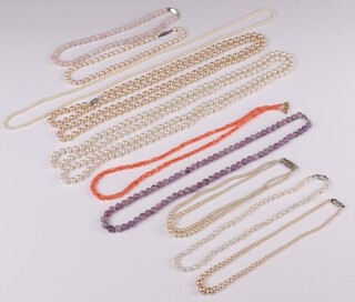 A string of amethyst coloured hardstone beads, a string of white hardstone beads and a collection of other bead necklaces 