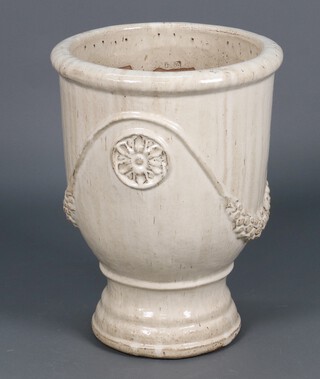 A circular terracotta planter with applied decoration, raised on a circular foot 72h x 47 diam. 