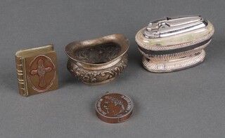 An embossed boat shaped silver salt 30grams, a Ronson silver plated Queen Anne table lighter formed from a coin and a vesta case in the form of a bible  