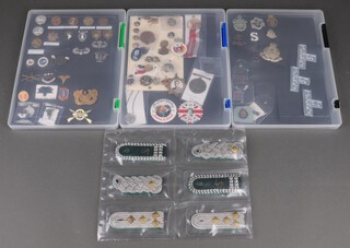 Three pairs of Continental military epaulettes and a collection of American military and British civilian Coronation badges etc, contained in 4 cases 