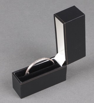 An engraved hollow silver bangle 