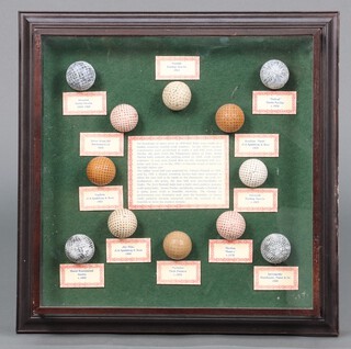 A framed collection of 12 facsimile golf balls 45h x 44w 