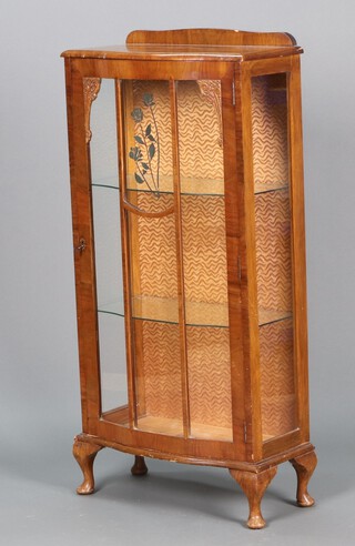 An Art Deco walnut display cabinet enclosed by astragal glazed doors on cabriole supports 123h x 59w x 30d  