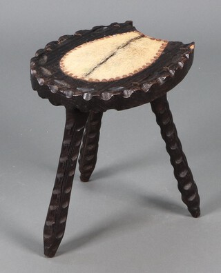 A carved hardwood horseshoe shaped stool on turned supports 40h x 30w x 35d 