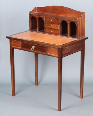 An 18th Century style mahogany writing table, the raised back fitted 3 drawers flanked by 4 pigeon holes, the base fitted a drawer, raised on square tapered supports 79h x 107w x 52d 