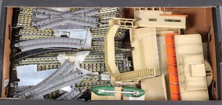 A Hornby Dublo level crossing, station building, platform, foot bridge and rails, contained in a fruit box 