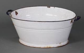 A blue and white enamelled twin handled oval bath 27cm h x 73cm w x 48cm d (some chips to enamel) 