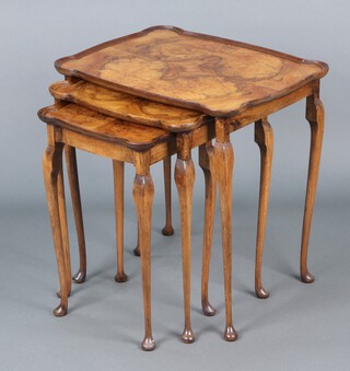 A nest of 3 1950's shaped coffee tables with quarter veneered tops, raised on cabriole supports 56h x 